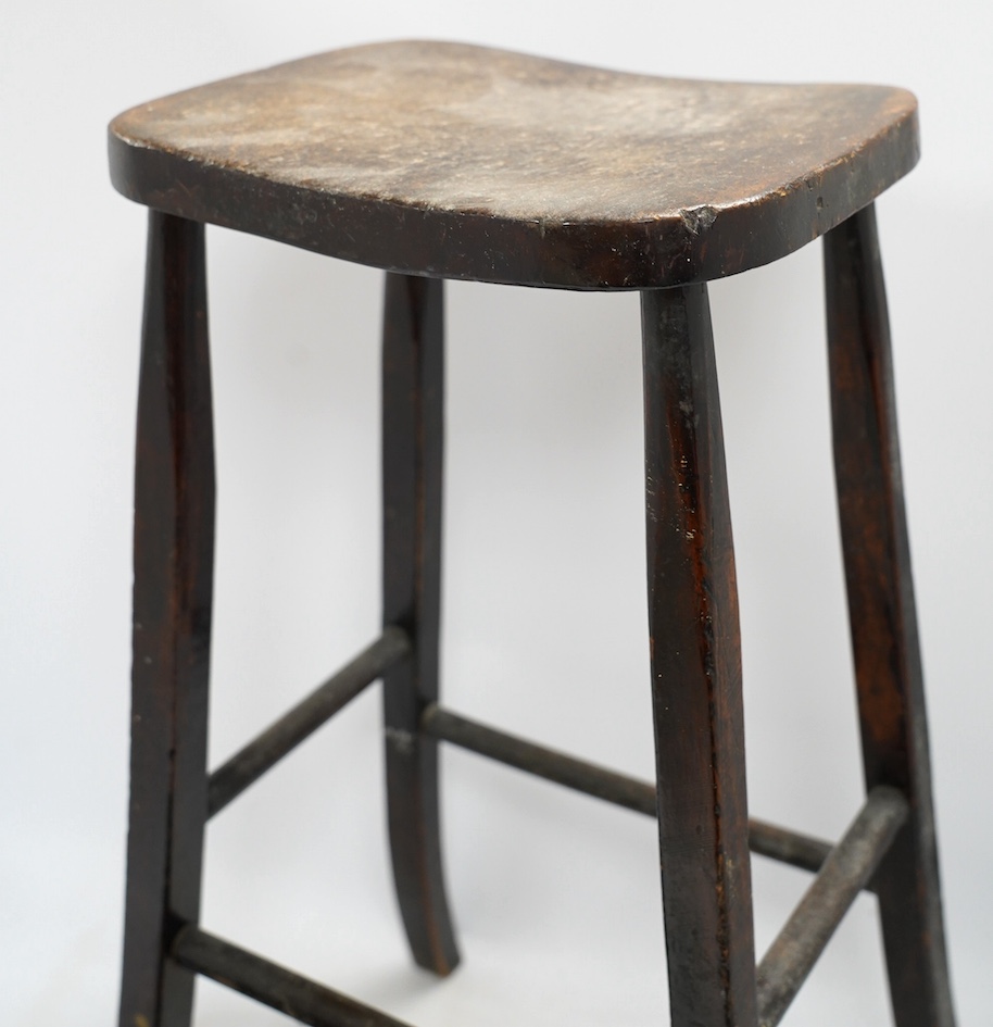 A Victorian elm and beech stool, 54cm high, together with a smaller child's stool. Condition - fair
